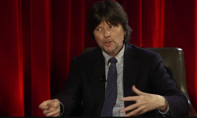 Ken Burns reviewing documentary footage with narration script