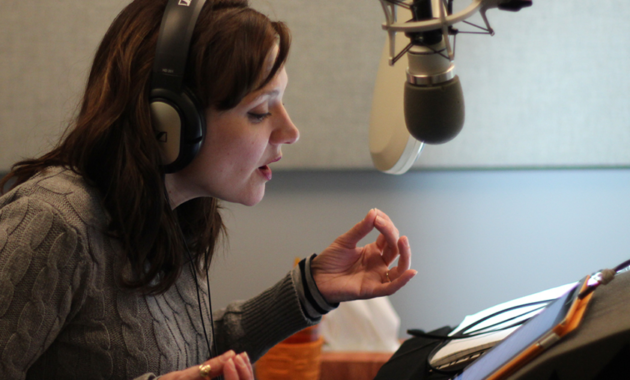 Voice actor practicing breathing exercises for narration in a recording studio